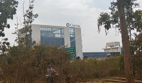 Wide view of the modern Centum corporate building with glass architecture located near the Purva Northern Lights project site