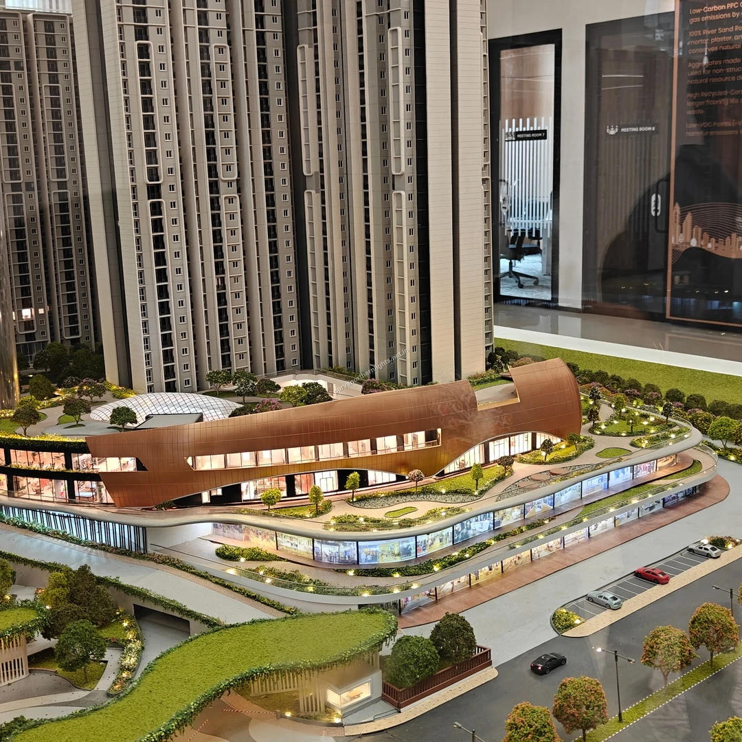 Wide angle miniature display of the striking clubhouse building flanked by residential towers and ground-level driveways recorded on mar 13