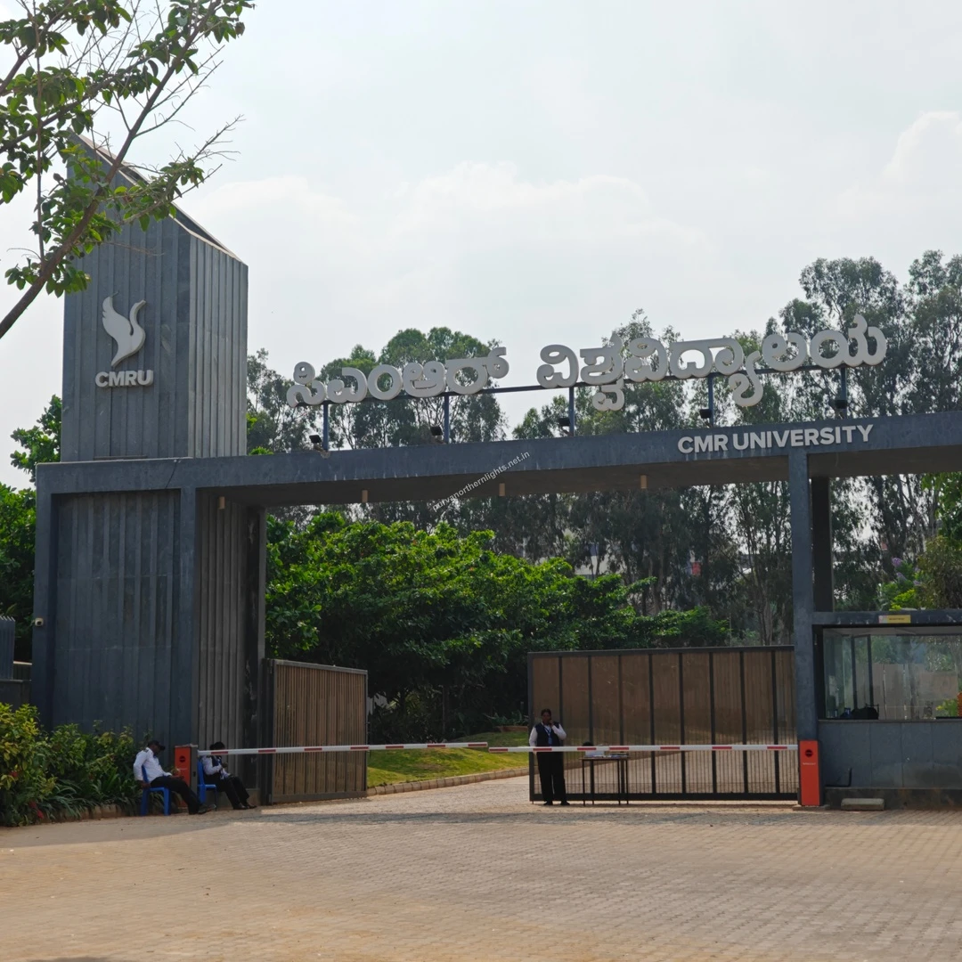 CMR Boom Barrier The entrance of CMR University showing a security guard stationed by the boom barrier regulating campus access.