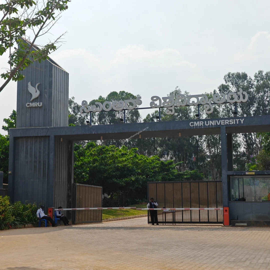 CMRU Gateway View A wide exterior shot of the CMR University gates surrounded by lush greenery, taken on a clear Mar 13 afternoon.