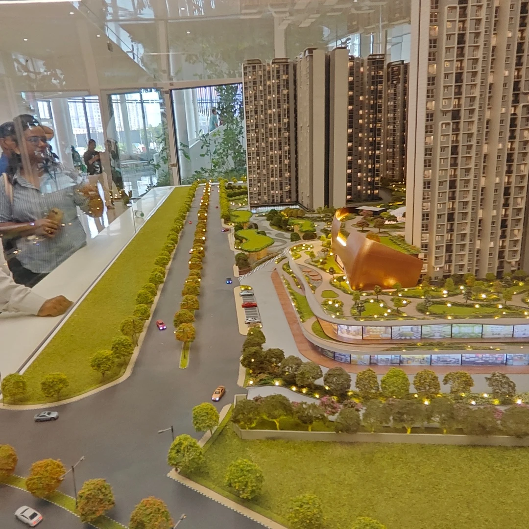 Wide miniature perspective documented on mar 13 focusing on the entry boulevard, expansive green buffering zones, and modern architectural design at Purva Northern Lights