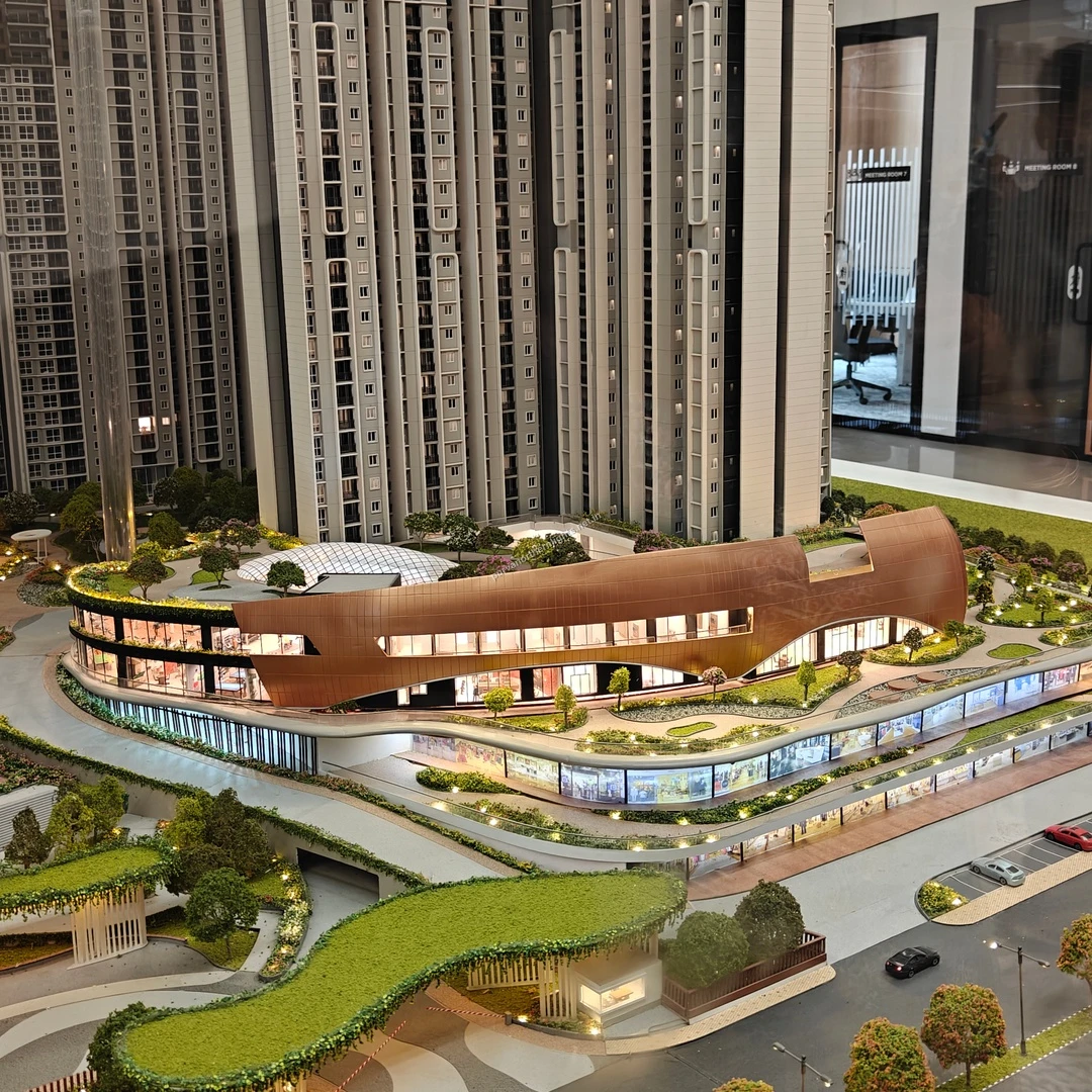Highly detailed miniature showcasing the futuristic copper-toned clubhouse architecture and lower amenity levels at Purva Northern Lights