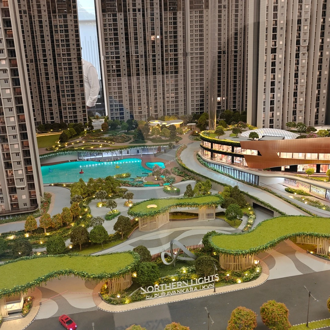 Expansive miniature view showcasing the grand entrance signage, large swimming pool, and modern clubhouse facilities at Purva Northern Lights