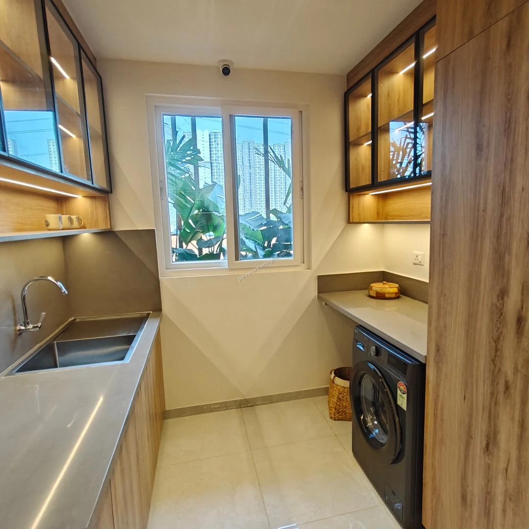 Functional kitchen utility area featuring a dedicated space for a washing machine, additional storage, and a large window for ventilation