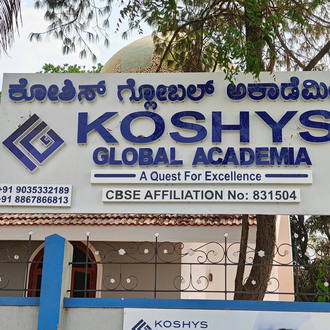 Koshys Main Sign The large outdoor signboard for Koshys Global Academia highlighting its CBSE affiliation and contact details near Purva Northern Lights.