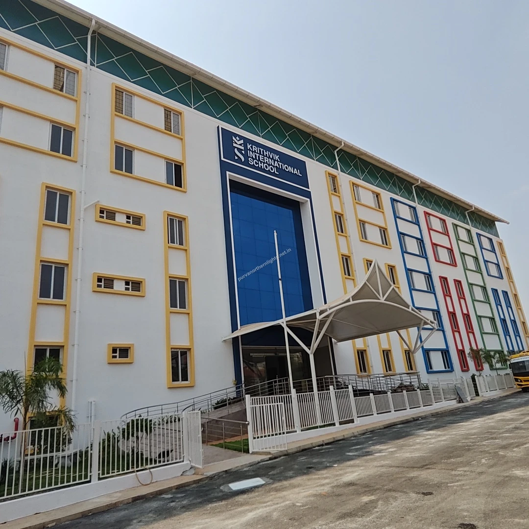 Krithvik Main Entrance A wide architectural view showing the grand entrance canopy and colorful panels of Krithvik International School located close to the project.