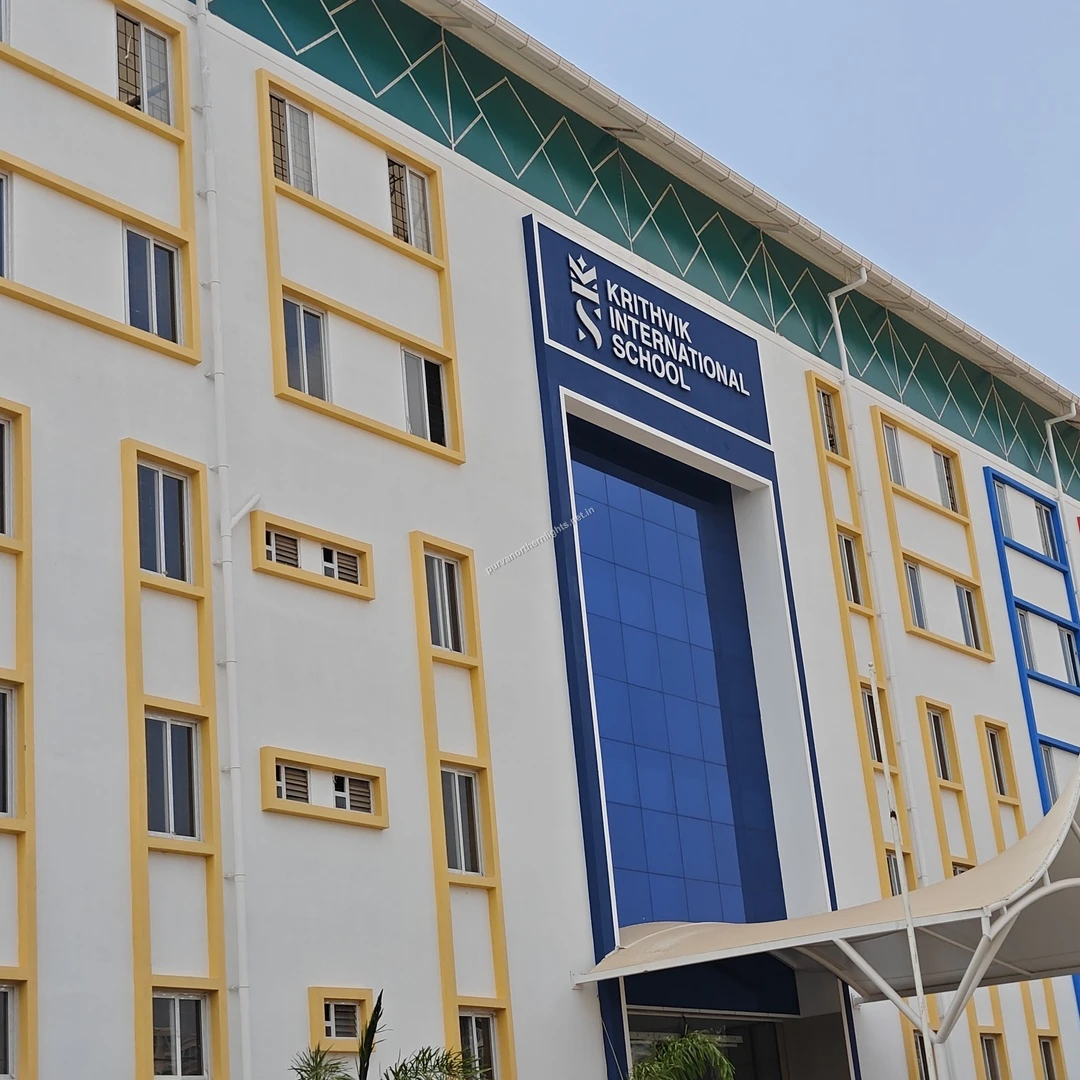 Krithvik School Facade A clear view of the modern white and blue building facade of Krithvik International School near Purva Northern Lights.