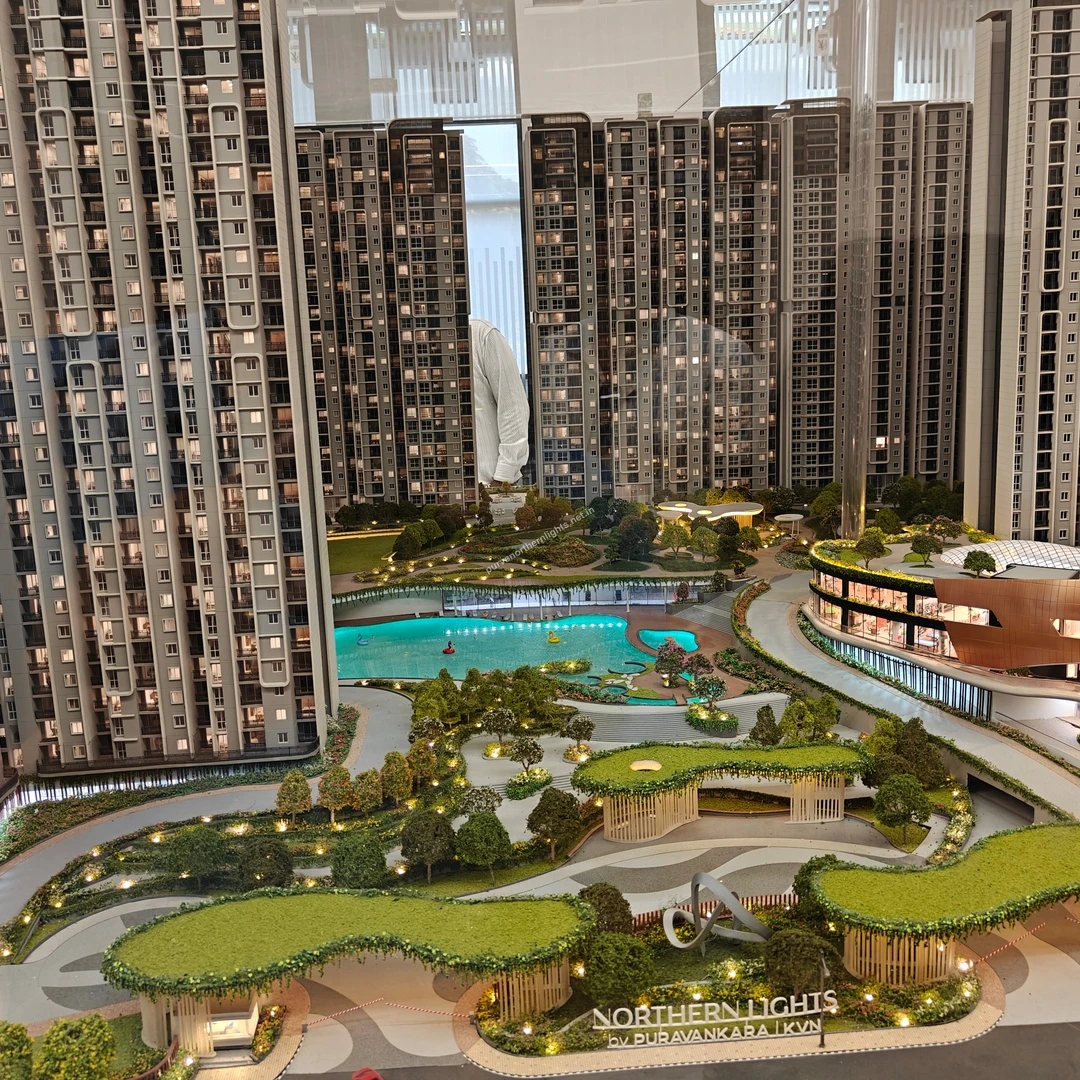 Detailed miniature landscape overview displaying the project signage, abstract sculpture, and sprawling pool area at Purva Northern Lights on mar 13
