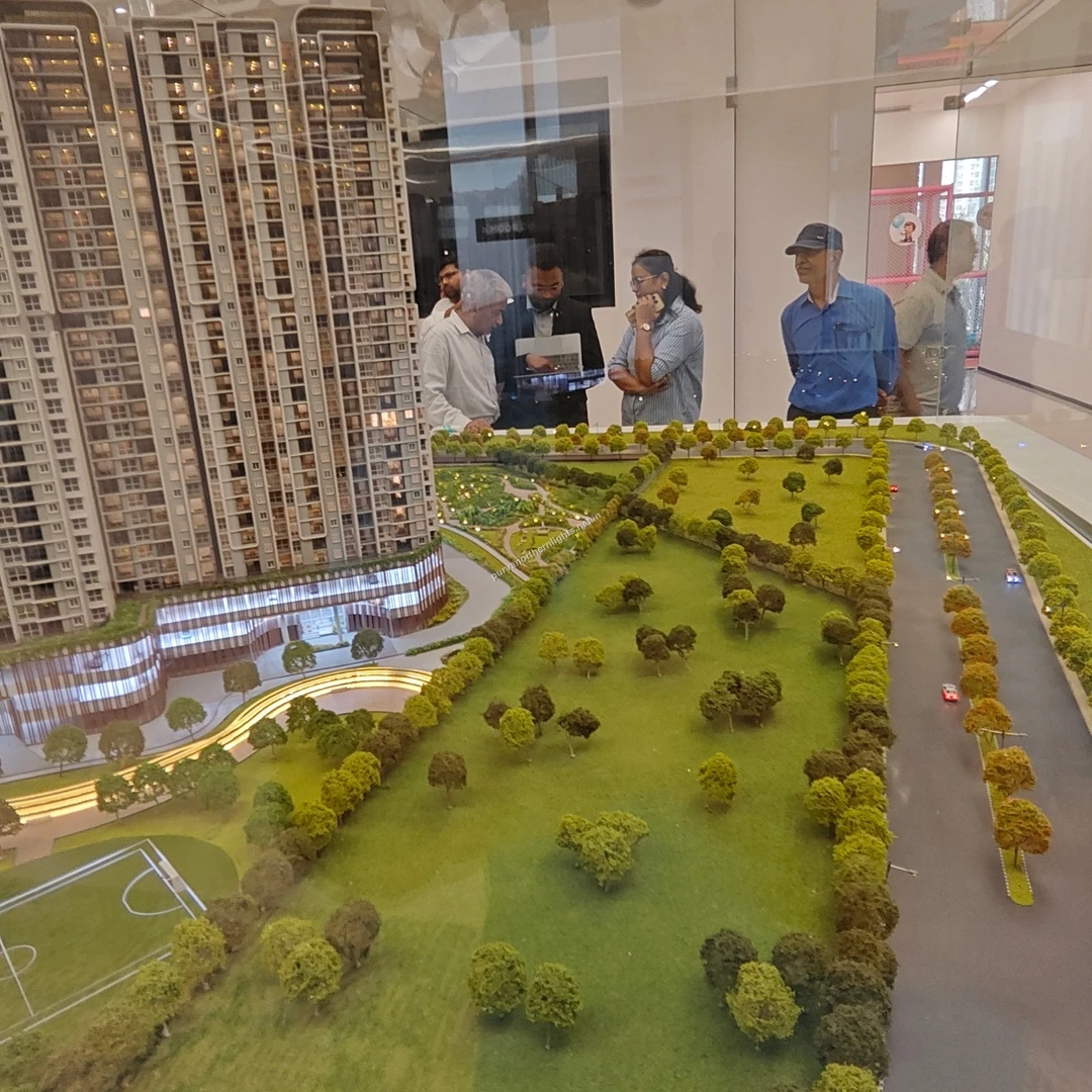 Expansive view of the landscaped open lawn area and peripheral tree lined avenue within the architectural miniature of Purva Northern Lights