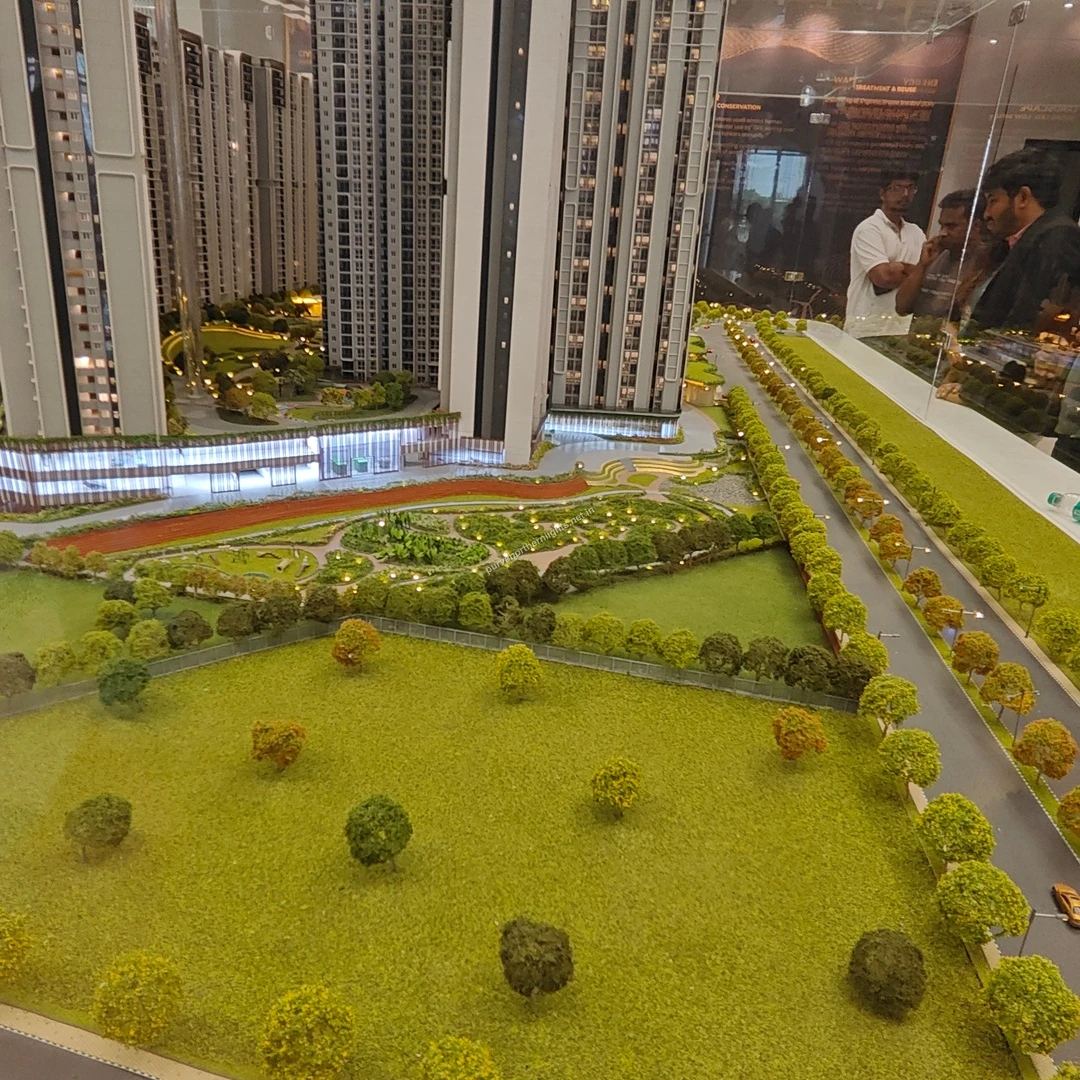 Wide display of the main entrance boulevard and vast grassy recreational spaces at the Purva Northern Lights miniature model recorded on mar 13