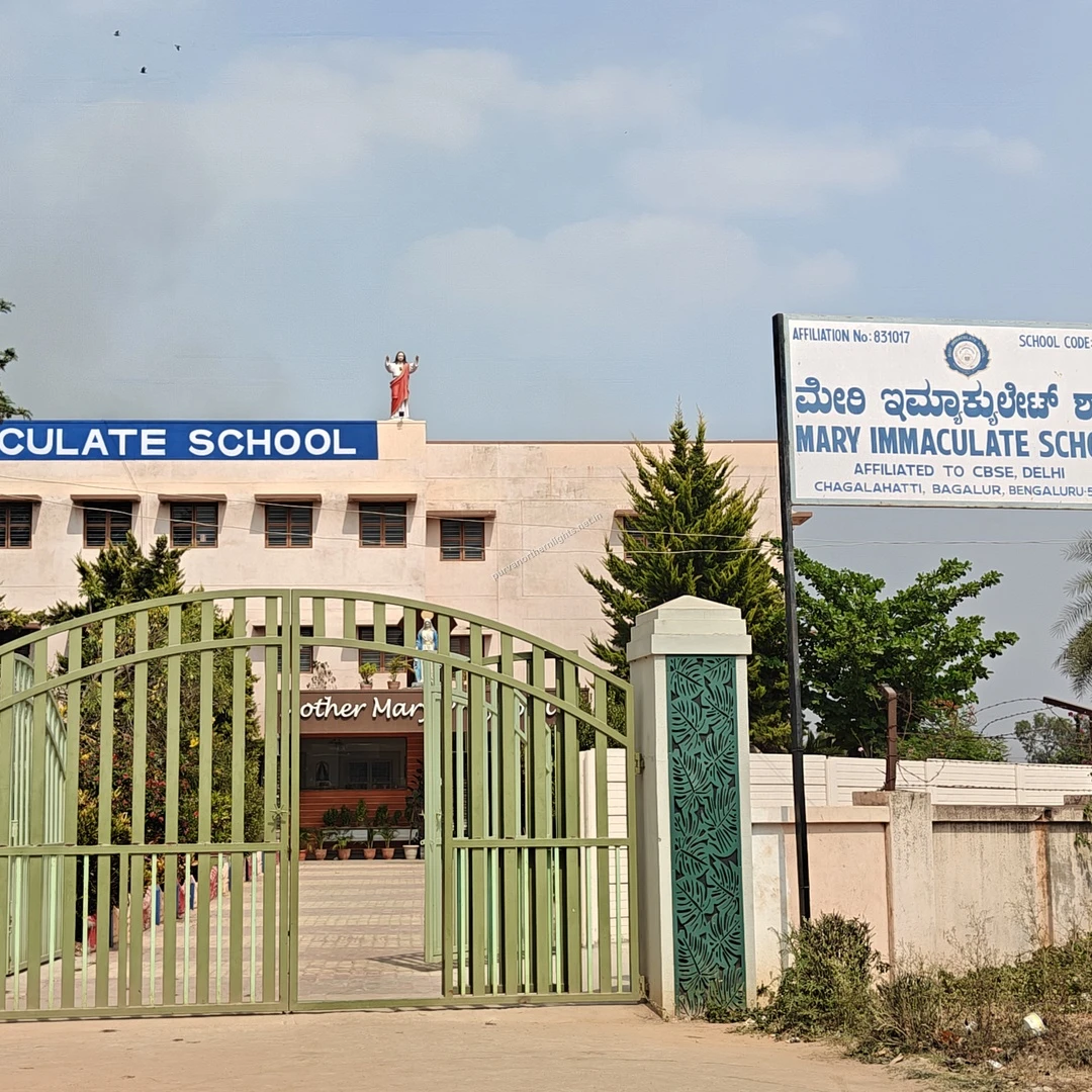 Mary Immaculate Gate The secure green entry gates and main multi-story building of Mary Immaculate School, an educational hub near the project.