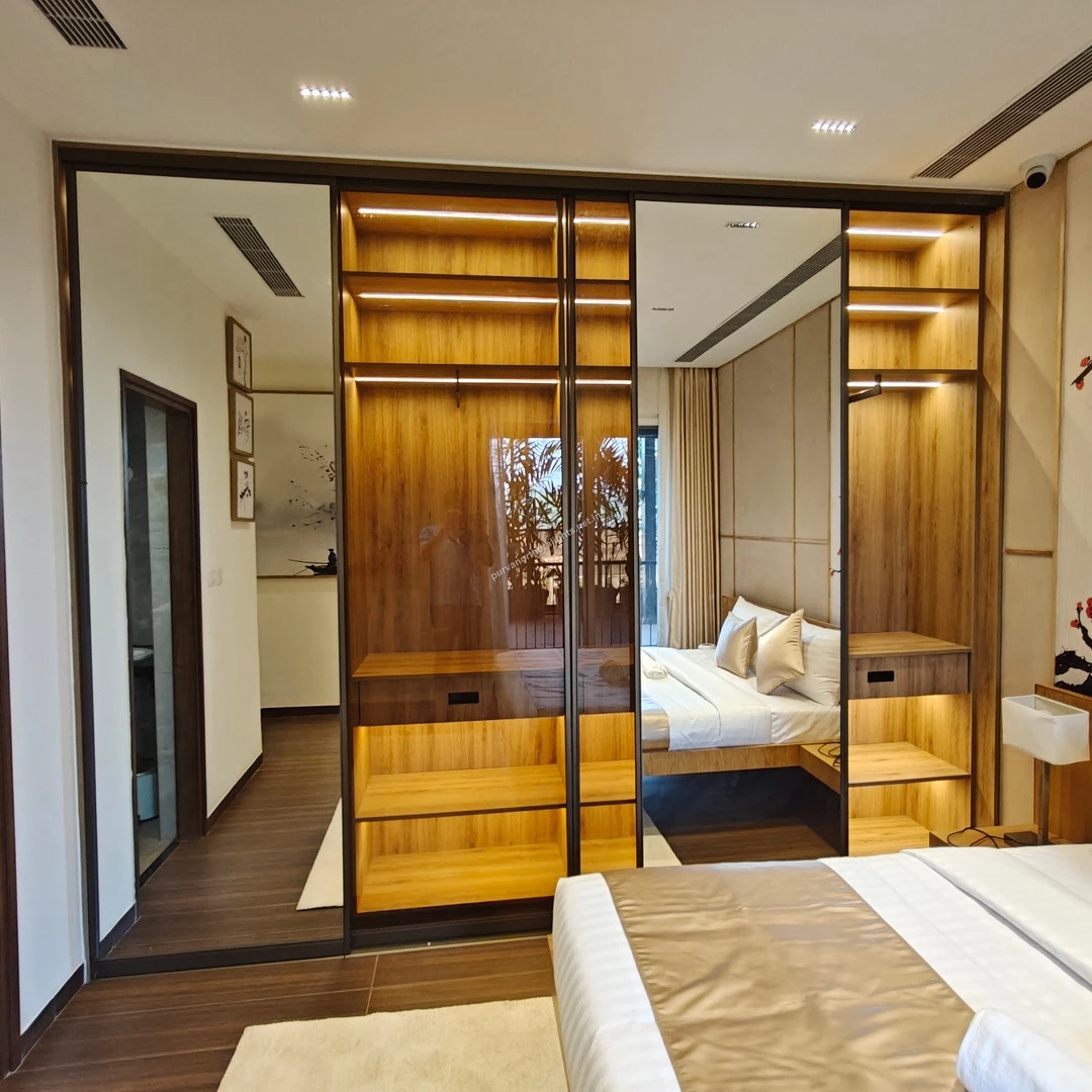 Close-up of the floor-to-ceiling mirrored sliding wardrobe in the master bedroom reflecting the modern interior design of Purva Northern Lights