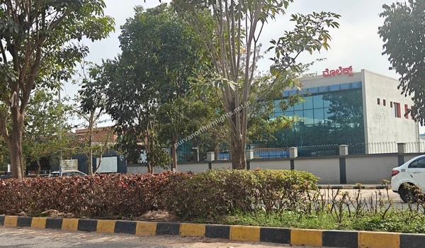 The Molex India office building featuring a blue glass facade and surrounding greenery located near Purva Northern Lights