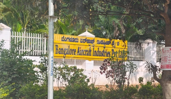 Yellow signage board of Bangalore Aircraft Industries Pvt Ltd located near Purva Northern Lights