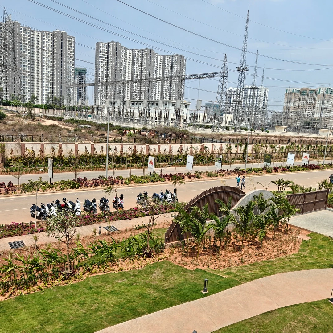 Scenic overlook of the access boulevard and meticulously designed garden beds at Purva Northern Lights, mar-13 view