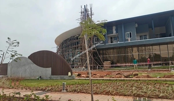 Exterior view of the Purva Northern Lights clubhouse showing glass facade and landscaping progress