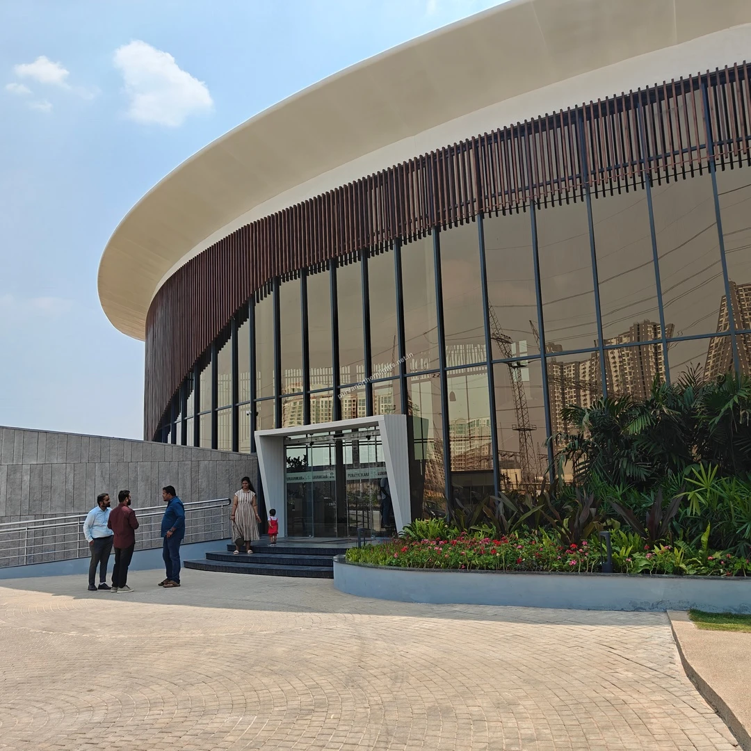 Contemporary curved glass architecture at the main entrance of the Purva Northern Lights experience center, documented on mar-13