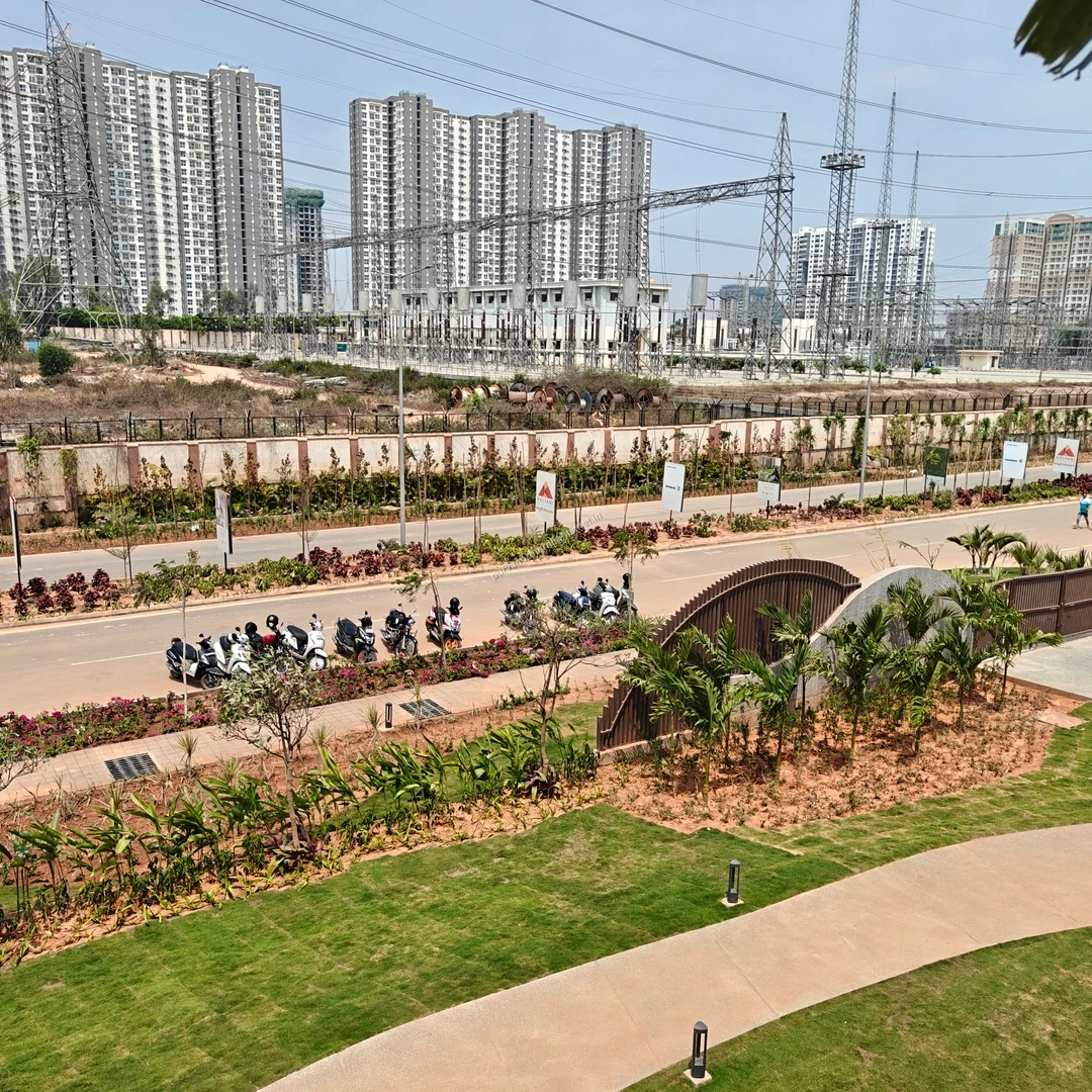 View of the beautifully manicured lawns and entrance driveway at the Purva Northern Lights development, recorded on mar-13