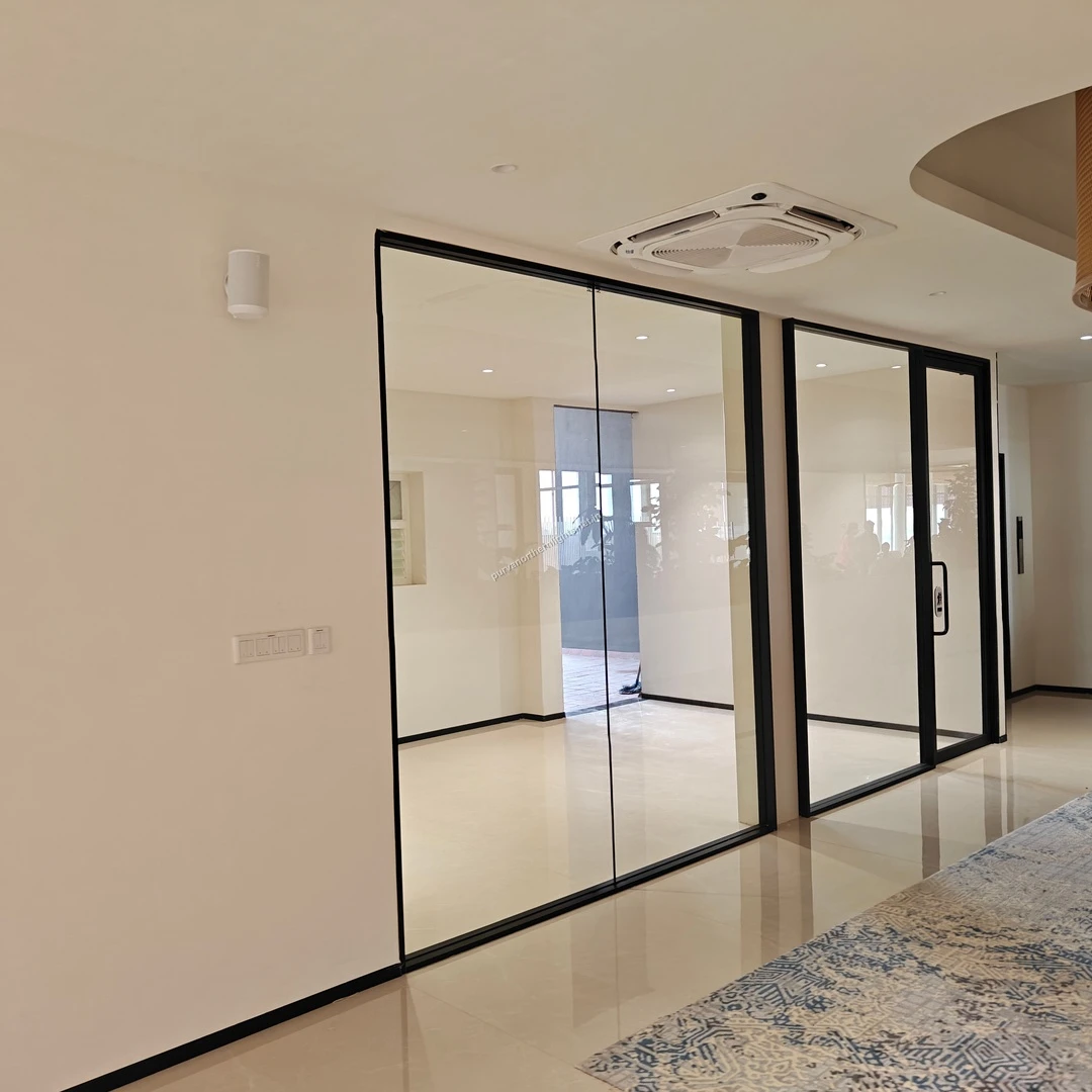 Elegant glass-partitioned meeting rooms for private client discussions at the Purva Northern Lights sales office