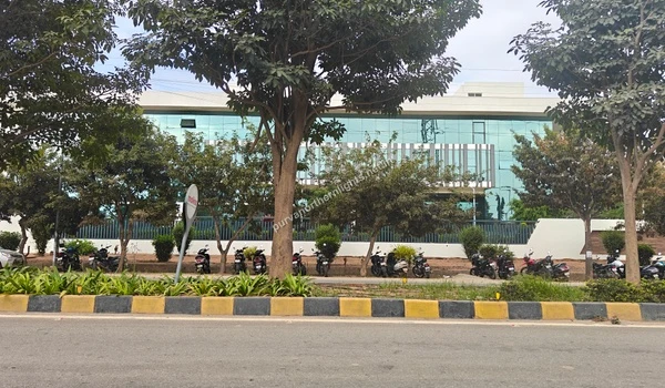 A wide view of a contemporary glass-fronted industrial building in the Aerospace Park vicinity of Purva Northern Lights.