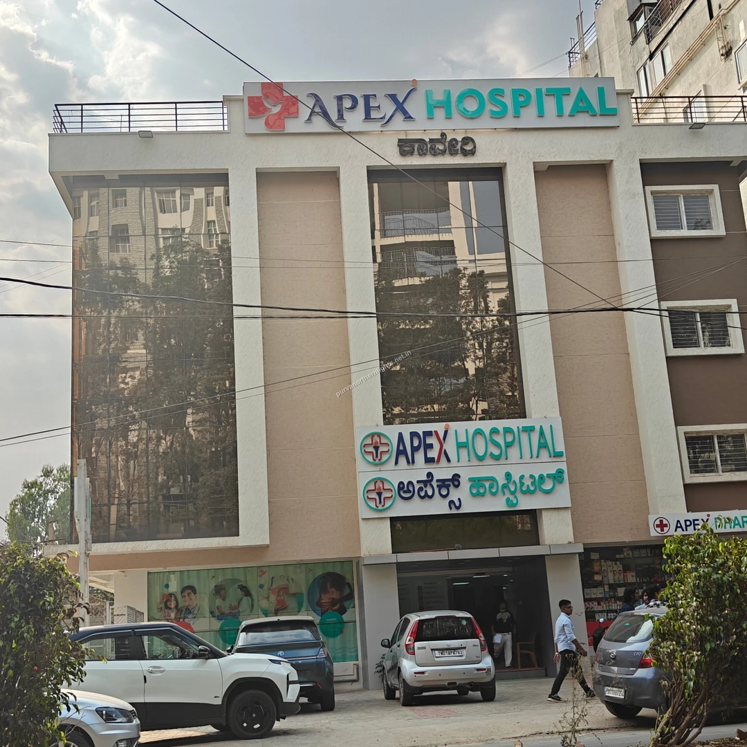 The modern glass facade of Apex Hospital showcasing the advanced medical amenities available a short distance from Purva Northern Lights.