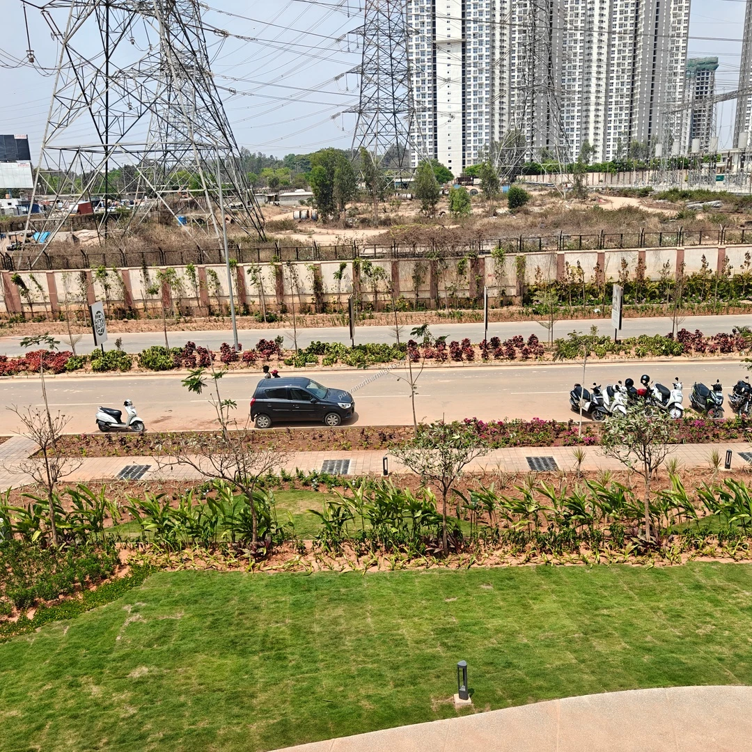 Elevated perspective of the landscaped entrance road and surrounding infrastructure at Purva Northern Lights