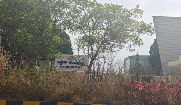Signage board of System Controls company obscured by trees near Purva Northern Lights