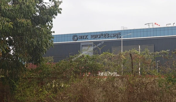 Exterior view of the RTX office building with blue glass facade and corporate signage located in the vicinity of Purva Northern Lights