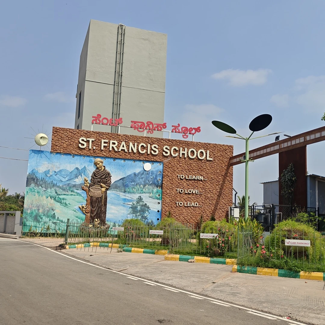 St Francis Main Gate A wide view of the beautifully landscaped entrance and gateway to St. Francis School with its inspirational motto displayed on the wall.