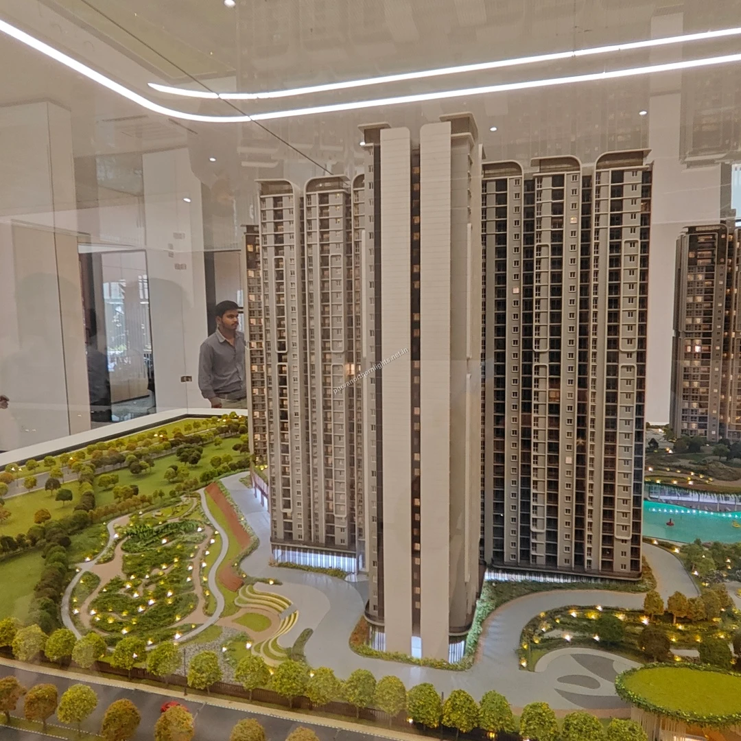 Close-up scale model view highlighting the residential tower drop-off zone and adjacent courtyard gardens at Purva Northern Lights